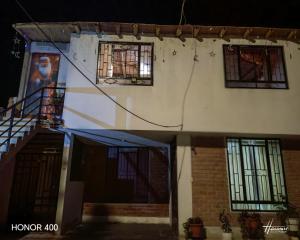 a house with a staircase and windows on it at Casita de camucha segundo piso in Chincha Baja