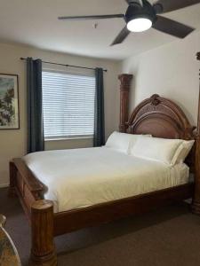 a bedroom with a large bed with a ceiling fan at Low Tide Lounge in Oceano