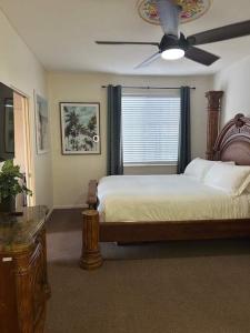 a bedroom with a bed and a ceiling fan at Low Tide Lounge in Oceano