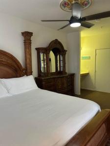 a bedroom with a bed and a ceiling fan at Low Tide Lounge in Oceano