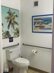 a bathroom with a toilet with a picture on the wall at Low Tide Lounge in Oceano +4 photos