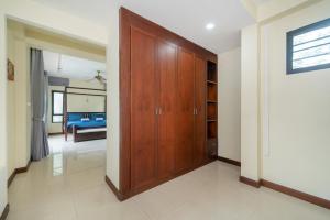 a room with a wooden closet and a bedroom at Rawai - 3 BR Private Pool Villa - Phoomjai Villa in Rawai Beach