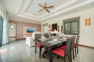 a dining room with a table and chairs at Rawai - 3 BR Private Pool Villa - Phoomjai Villa in Rawai Beach
