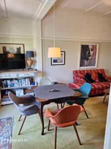 a living room with a table and chairs and a couch at The Gables - Circa 1880 - Classic Bowral Property in Bowral