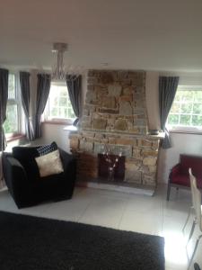 a living room filled with furniture and a fireplace at Rosemorran Holiday Apartments in St Ives