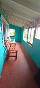 two benches in a room with blue walls and windows at Cabaña Quiroz in Valdivia