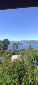 a view of a body of water with a white truck at Cabaña Quiroz in Valdivia
