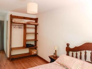 a bedroom with a bed and a book shelf at Casa Cabaña Los Zorzales Santa Clara del Mar-Argentina in Santa Clara del Mar