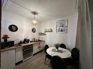 a kitchen with a table and a sink and a table and chairs at Apparemment Gütenberg-Cathedrale in Strasbourg +9 photos