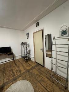 a room with a white wall and a door and a ladder at Apparemment Gütenberg-Cathedrale in Strasbourg