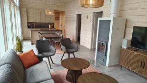 a living room with a couch and a tv and a table at Hakoranta in Ruka