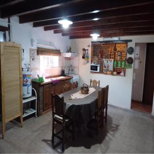 a kitchen with a table and chairs in a room at Claro de Luna in Los Reartes