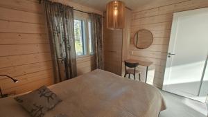 a bedroom with a bed and a table and a chair at Hakoranta in Ruka