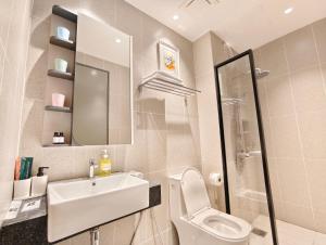 a bathroom with a sink and a toilet and a mirror at 22 Macalisterz - King Suite - 65"QLED TV - Disney - Pop Corn - Sky Pool in George Town