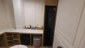 a kitchen with a black refrigerator and a table at Hotel Label Seongnam in Seongnam
