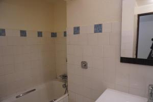 a bathroom with a tub and a sink and a mirror at Camellia 2 Duplex in Sainte-Anne +7 photos