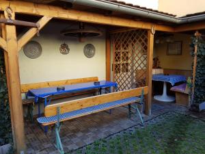 a wooden patio with a bench and a table at Ferienwohnung Alte Stadtmauer in Bamberg