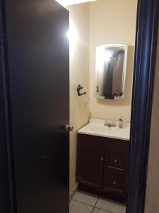 a bathroom with a sink and a mirror at Departamento Ruze Privado-Tranquilo in Plan Libertador +39 photos