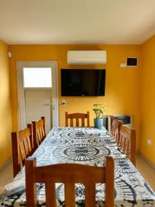a dining room with a table and chairs at Kaike in Caleta Olivia