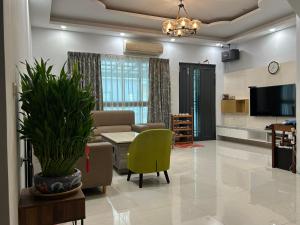 a living room with a couch and a tv at Shower & Sleep in Huxi