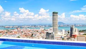 a swimming pool with a view of a city at 22 Macalisterz - King Suite - 65"QLED TV - Disney - Pop Corn - Sky Pool in George Town