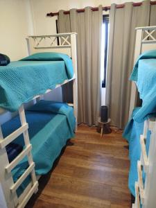 a room with two bunk beds and a window at Casa a estrenar En Trapiche - Pileta privada in Trapiche +13 photos