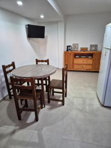 a kitchen with a table and chairs and a refrigerator at Rent Santa Clara in Santa Clara del Mar +4 photos