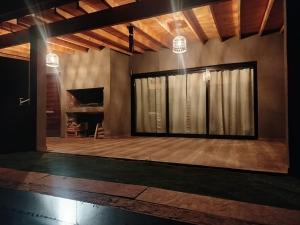 a room with a stage with a large window at Casa a estrenar En Trapiche - Pileta privada in Trapiche