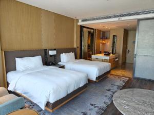 a hotel room with two beds and a couch at JW Marriott Hotel Taiyuan in Taiyuan +51 photos