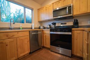 a kitchen with a stove and a microwave at Moab Adventure Basecamp in Moab +41 photos