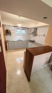 a large kitchen with a table in a room at Malvinas Casa de Playa in Necochea