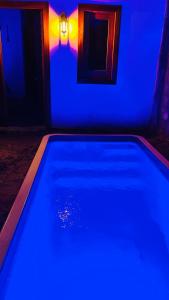 a swimming pool with blue lights in a room at Casa Sophi in Cruz
