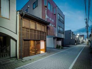 a building with a garage on a city street at Itose Machiya House in Kanazawa