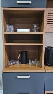 a wooden shelf with glasses in a kitchen at Sítio Menezes in Parnaíba +15 photos