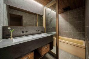 a bathroom with a sink and a shower at Itose Machiya House in Kanazawa +43 photos