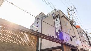 a building with a sign on the side of it at 엘루이호텔 in Busan