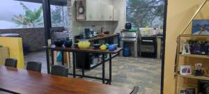 a kitchen with a table with vases on it at Finca Agrópolis de Silvania in Silvania