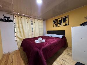 a bedroom with a bed with a purple blanket at Finca Agrópolis de Silvania in Silvania +25 photos