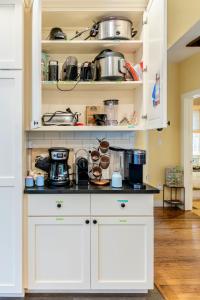 a kitchen with white cabinets with pots and pans at 1890 CapeCod farmhouse:Charming, Private, Spacious in Saugerties +38 photos