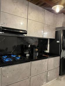 a kitchen with a stove top oven in a kitchen at Apto Domus in Pamplona +3 photos
