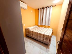 a small bedroom with a bed and a window at CASA CONTAINER Vsa in Vitória de Santo Antão +14 photos