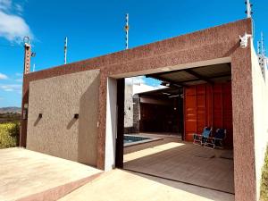 a building with an open door to a patio at CASA CONTAINER Vsa in Vitória de Santo Antão