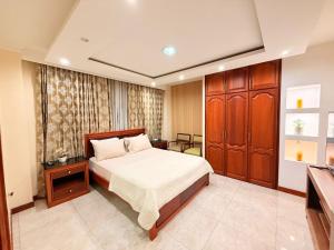 En eller flere senge i et værelse på Suites Ejecutivas Unioro