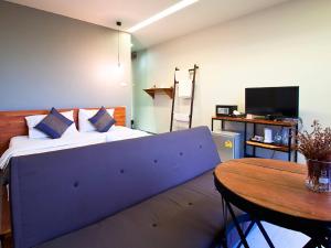 a bedroom with a large bed and a table at 3 Laan House in Chiang Mai