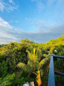 a view from the balcony of a resort with palm trees at MO’s Agro in Pāppinisseri