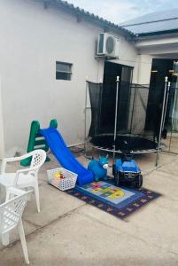 a childs play area with a slide and a playground at Casa de Hóspedes Kipper in São Gabriel