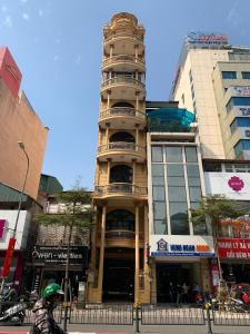 a tall building with a tower on top of it at Kim Anh Hotel in Hanoi
