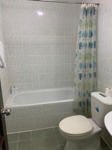 a bathroom with a white toilet and a bath tub at Kim Anh Hotel in Hanoi +7 photos