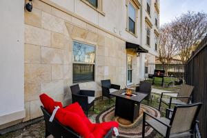 a patio with chairs and a couch and a table at Fireside Double Kings Midtown Luxe Suite in Houston