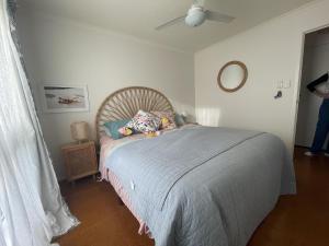 a bedroom with a bed and a ceiling fan at La Sirena, Venus Bay in Venus Bay